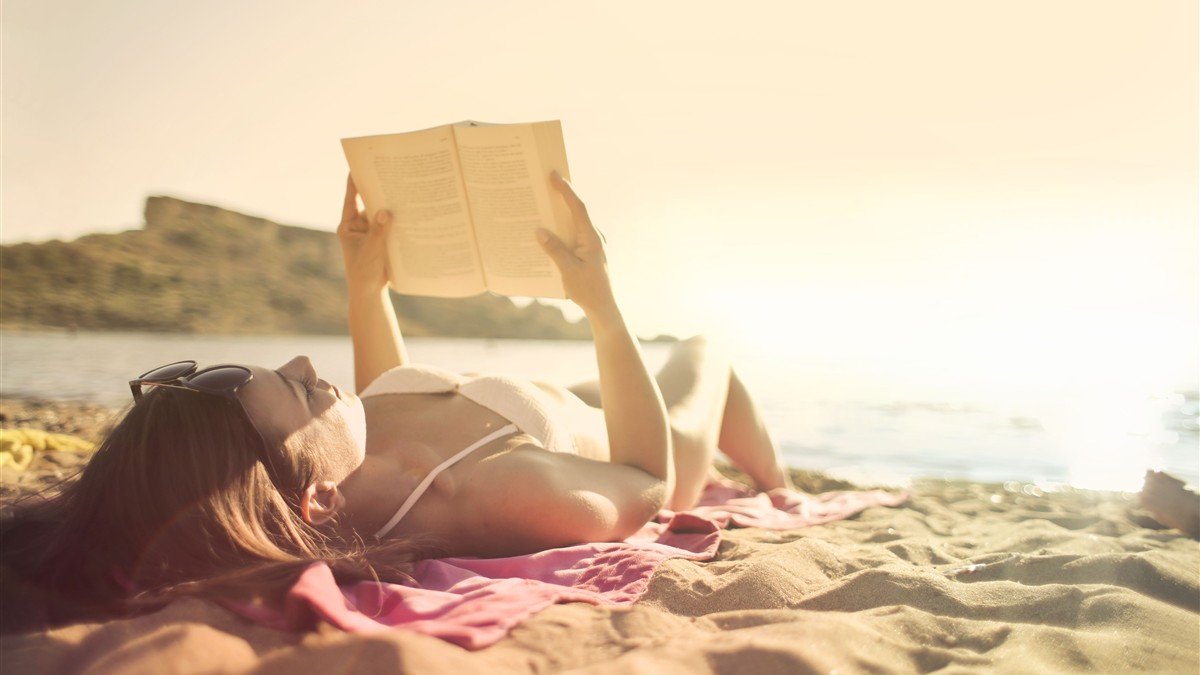 Mulher relaxando na praia durante período de férias planejadas